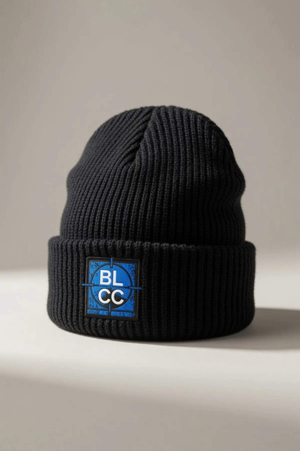 Black ribbed BLCC beanie with a woven logo patch on the cuff